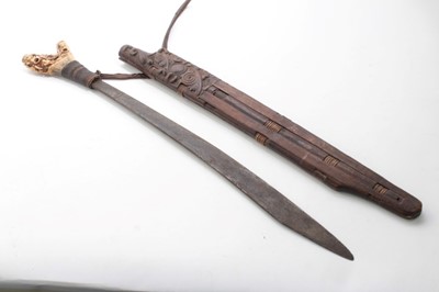 Lot 797 - Borneo Dayak Head hunters sword with carved bone hilt with rope bound grip, in carved wood scabbard