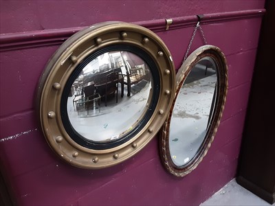 Lot 898 - Georgian style circular convex wall mirror, together with an oval wall mirror (2)