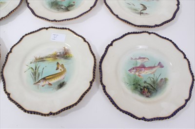Lot 50 - Late Victorian Royal Worcester porcelain fish service, each piece with overpainted transfer decoration depicting various fishes and gilded cobalt blue gadrooned edging  - comprising twelve plates,...