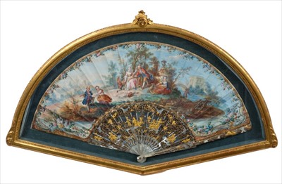 Lot 755 - Fine quality 18th century French fan with painted pastoral landscape with courting figures, carved and gilded mother of pearl struts, in a glazed gilt frame