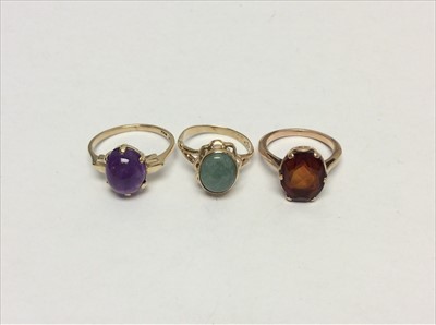 Lot 659 - Gold 9ct amethyst cabochon ring, green hardstone ring and one other quartz ring (3)