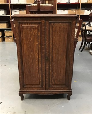 Lot 912 - Early 20th Century Oak record / music cabinet enclosed by a pair of panelled doors, with shelved interior