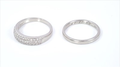 Lot 374 - Platinum and diamond eternity ring and platinum wedding ring