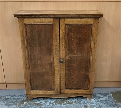 Lot 924 - Oak bookcase with panelled doors on bracket feet