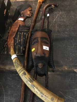 Lot 188 - Group of three various walking sticks, together with a carved wall mask and another similar (5)
