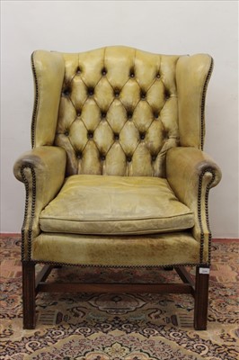 Lot 1294 - Georgian style leather upholstered wing armchair