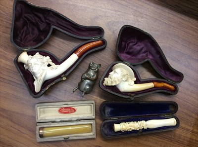 Lot 497 - Two Meerschaum pipes, cheroot holder with gold 9ct collar, one other and a novelty pig vesta case