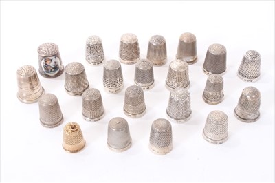 Lot 238 - A contemporary  9ct gold thimble and 22 other silver and white metal thimbles.