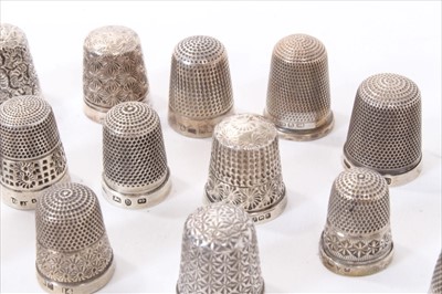 Lot 238 - A contemporary  9ct gold thimble and 22 other silver and white metal thimbles.