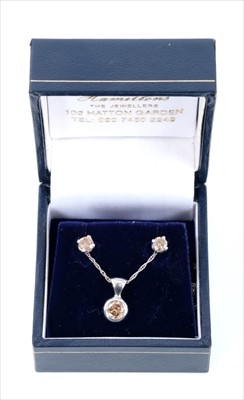 Lot 390 - Cinnamon diamond pendant and earrings, the round brilliant cut diamond pendant estimated to weigh approximately 0.40ct in 9ct white gold setting on chain, the single stone stud earrings estimated t...