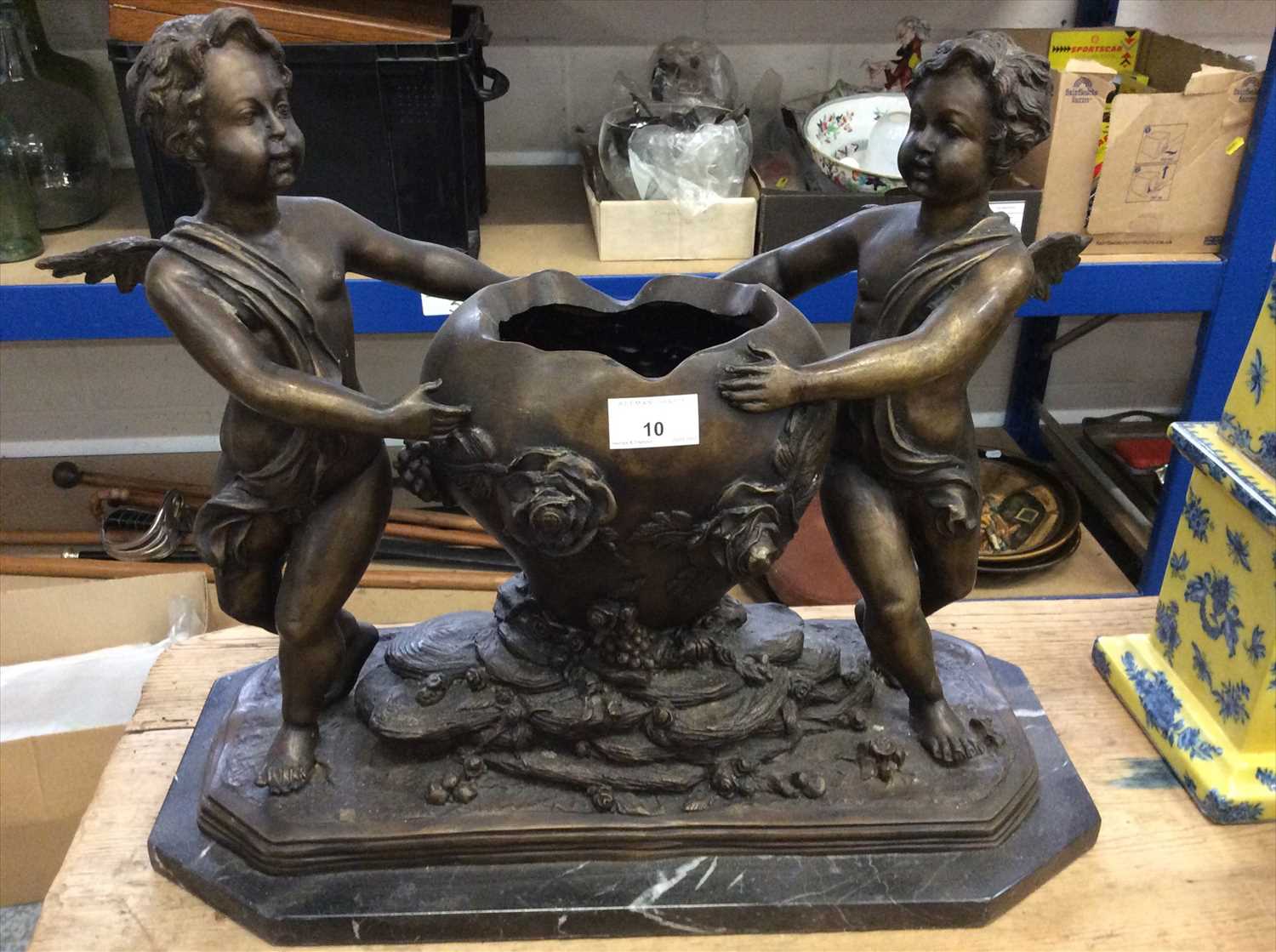 Lot 10 - Bronzed centrepiece with two putto flanking an urn, on marble base