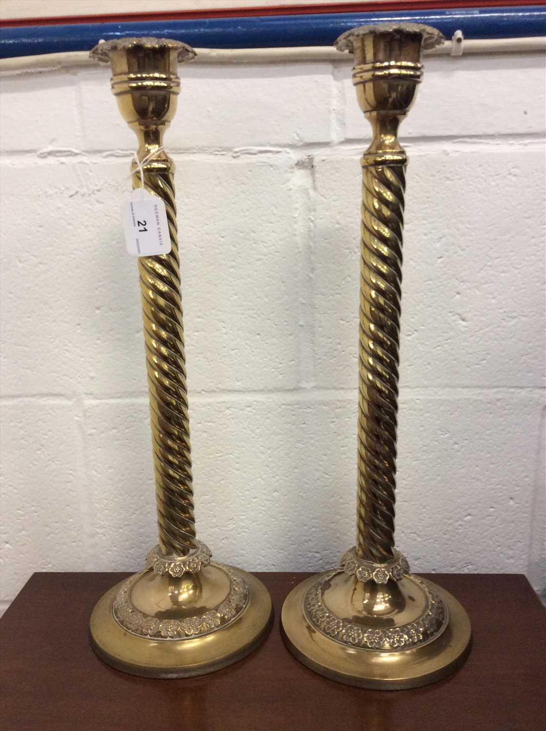 Lot 21 - Tall pair of brass candlesticks
