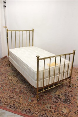 Lot 1317 - Pair of brass single beds with fitted mattresses and cover