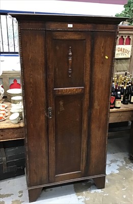 Lot 941 - 1930's oak hall cupboard with single panelled door, beaded decoration on bracket feet