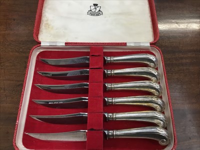 Lot 172 - Cased set of silver plated steak knives with pistol grip handles