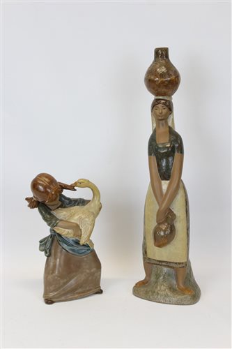 Lot 2187 - Two Lladro Gres figures - girl holding a swan...