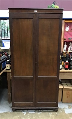 Lot 942 - Oak hall cupboard with panelled doors enclosing adjustable shelves on bracket feet