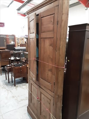 Lot 973 - Pine corner cupboard with shaped shelves enclosed by panelled doors