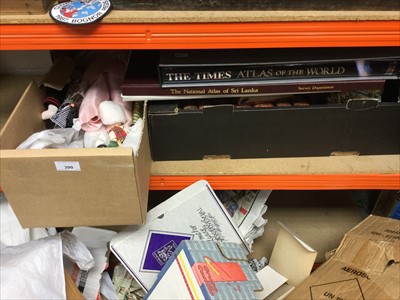 Lot 390 - Box of assorted world dolls, atlas's and other books