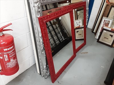 Lot 537 - A pair of red contemporary wall mirrors