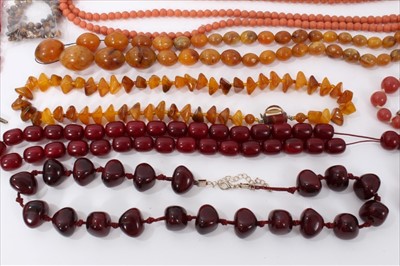 Lot 14 - Group amber type bead necklaces, simulated cherry amber, vintage coral jewellery, other beads and red resin model of galloping horses