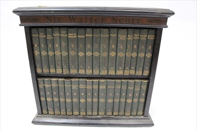 Lot 1292 - Miniature two shelf bookcase containing volumes by Sir Walter Scott