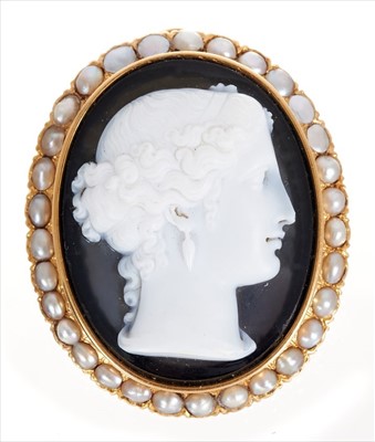 Lot 401 - Carved sardonyx cameo depicting a classical female bust, the oval gold mount with seed pearl border and pendant and brooch fitting 42mm x 35mm