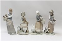 Lot 2223 - Four Lladro porcelain figures - girl with cat...