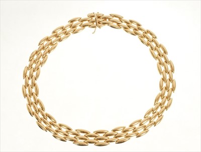 Lot 477 - Cartier 18ct gold necklace with articulated polished gold 'torpedo' links, signed Cartier and numbered 1002246. Approximately 43cm length