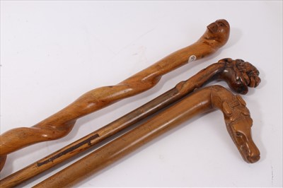 Lot 716 - Late 19th / early 20th century carved hardwood walking stick, another