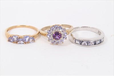 Lot 35 - Three 9ct gold purple stone dress rings