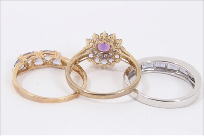 Lot 35 - Three 9ct gold purple stone dress rings