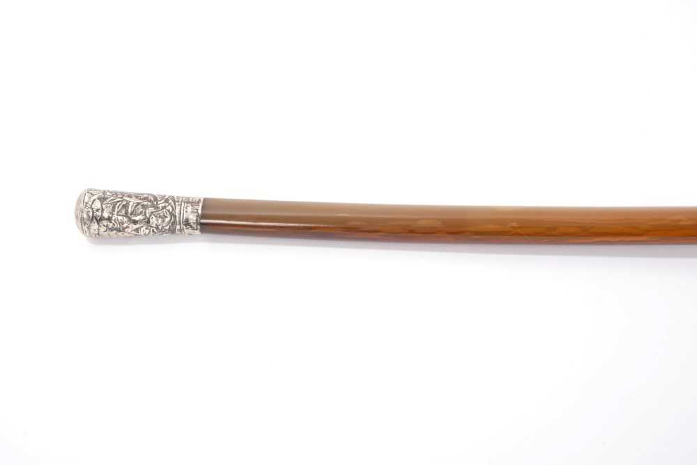 Lot 728 - 19th century Chinese silver mounted rhino horn walking stick, the silver terminal embossed with sages in landscapes, the tapering shaft with brass ferrule