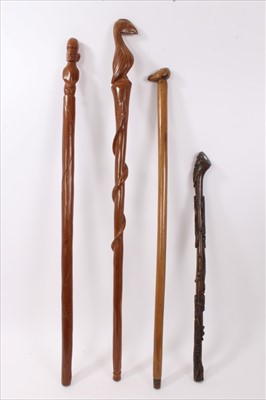 Lot 734 - 19th century carved hardwood tribal stick, together with three further carved wooden sticks