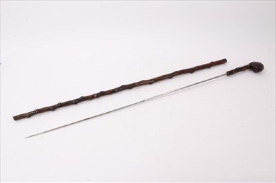 Lot 754 - Antique wooden sword walking stick, with club handle and naturalistic finish, 86cm long