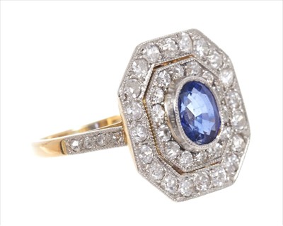 Lot 361 - Art Deco style sapphire and diamond cocktail ring with a central oval mixed cut blue sapphire surrounded by two concentric octagonal borders of old cut and brilliant cut diamonds in platinum mille...