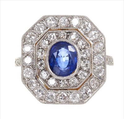 Lot 361 - Art Deco style sapphire and diamond cocktail ring with a central oval mixed cut blue sapphire surrounded by two concentric octagonal borders of old cut and brilliant cut diamonds in platinum mille...