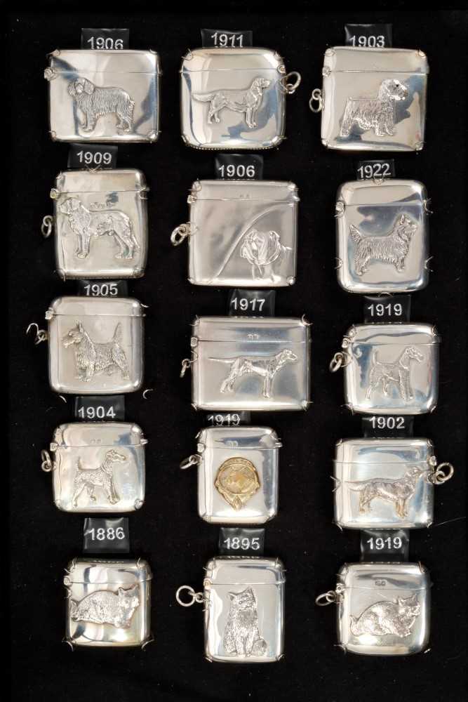 Lot 300 - Collection of fifteen Victorian and later silver vesta cases decorated in relief with dogs and cats (15)