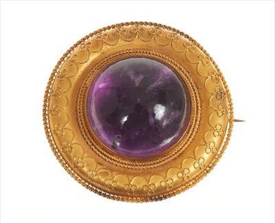 Lot 408 - Etruscan Revival gold and amethyst cabochon target brooch