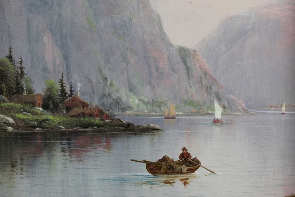 Lot 1072 - Nils Hans Christensen (1867-1939) oil on board - Norwegian Fjord with a figure in a boat, signed, in gilt frame, 30cm x 22cm