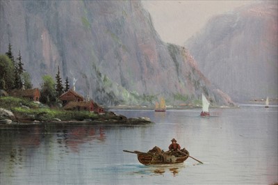 Lot 1072 - Nils Hans Christensen (1867-1939) oil on board - Norwegian Fjord with a figure in a boat, signed, in gilt frame, 30cm x 22cm