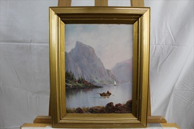 Lot 1072 - Nils Hans Christensen (1867-1939) oil on board - Norwegian Fjord with a figure in a boat, signed, in gilt frame, 30cm x 22cm