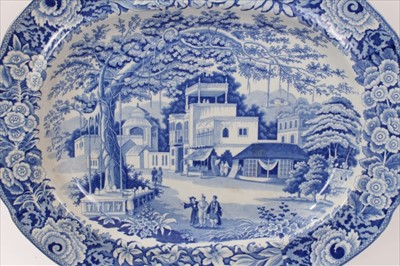 Lot 109 - Early 19th century Staffordshire blue and white transfer printed platter, decorated with an Oriental scene, and a pair of plates with matching pattern (3)