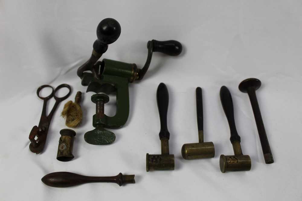 Lot 816 - An antique cartridge reloading tool, three brass shot and powder measures with wooden handles and other similar items