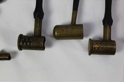 Lot 816 - An antique cartridge reloading tool, three brass shot and powder measures with wooden handles and other similar items