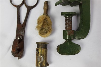 Lot 816 - An antique cartridge reloading tool, three brass shot and powder measures with wooden handles and other similar items