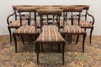 Lot 1369 - Set of eight Regency bar back dining chairs, each with pierced horizontal splat and slip in seat on sabre legs, to include a pair of scroll arm carvers