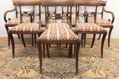 Lot 1369 - Set of eight Regency bar back dining chairs, each with pierced horizontal splat and slip in seat on sabre legs, to include a pair of scroll arm carvers