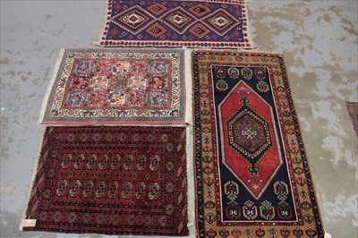 Lot 1415 - Tekke turkoman rug with claret ground and two rows of eight quartered medallions in geometric borders, 145 x 102cm together with three further decorative rugs