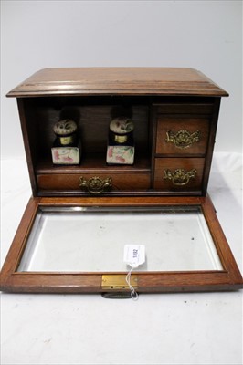 Lot 1892 - Edwardian oak glass-fronted stationery cabinet, with china inkwells and brass mounts, 38cm across